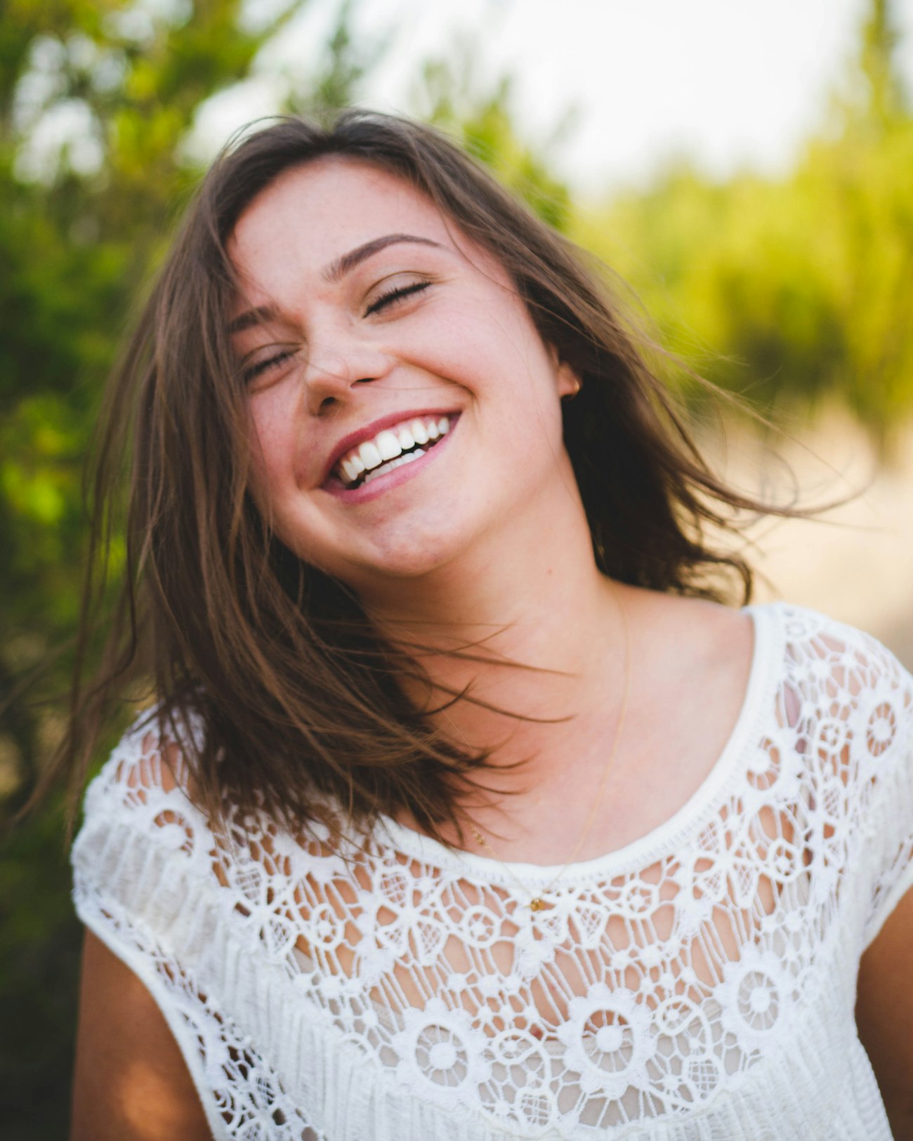 Woman laughing with a bright, healthy smile